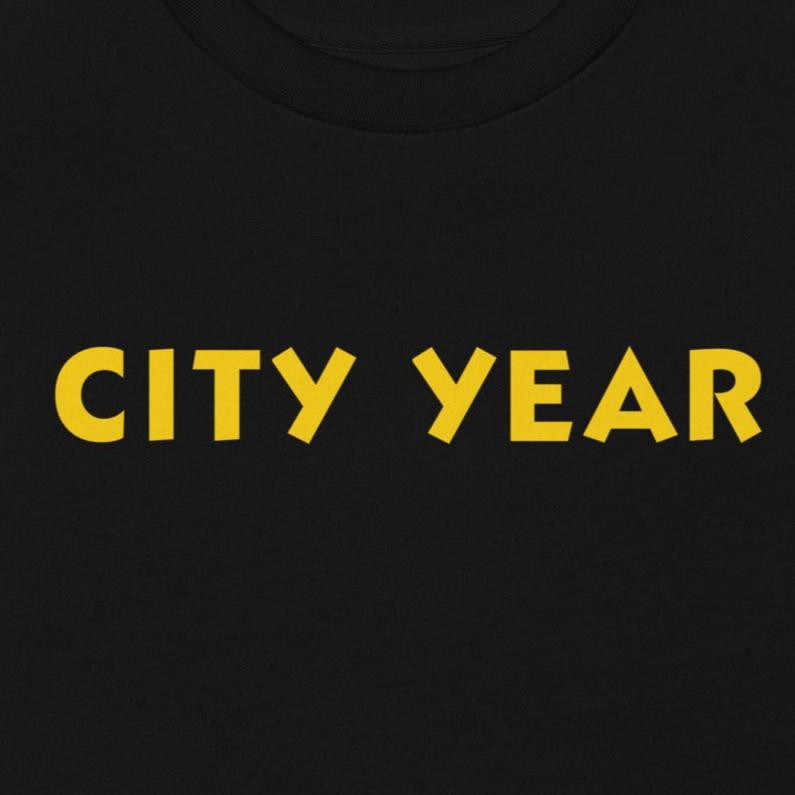 Unisex City Year Sweatshirt in black, featuring retro-inspired yellow text, casual and classic design.